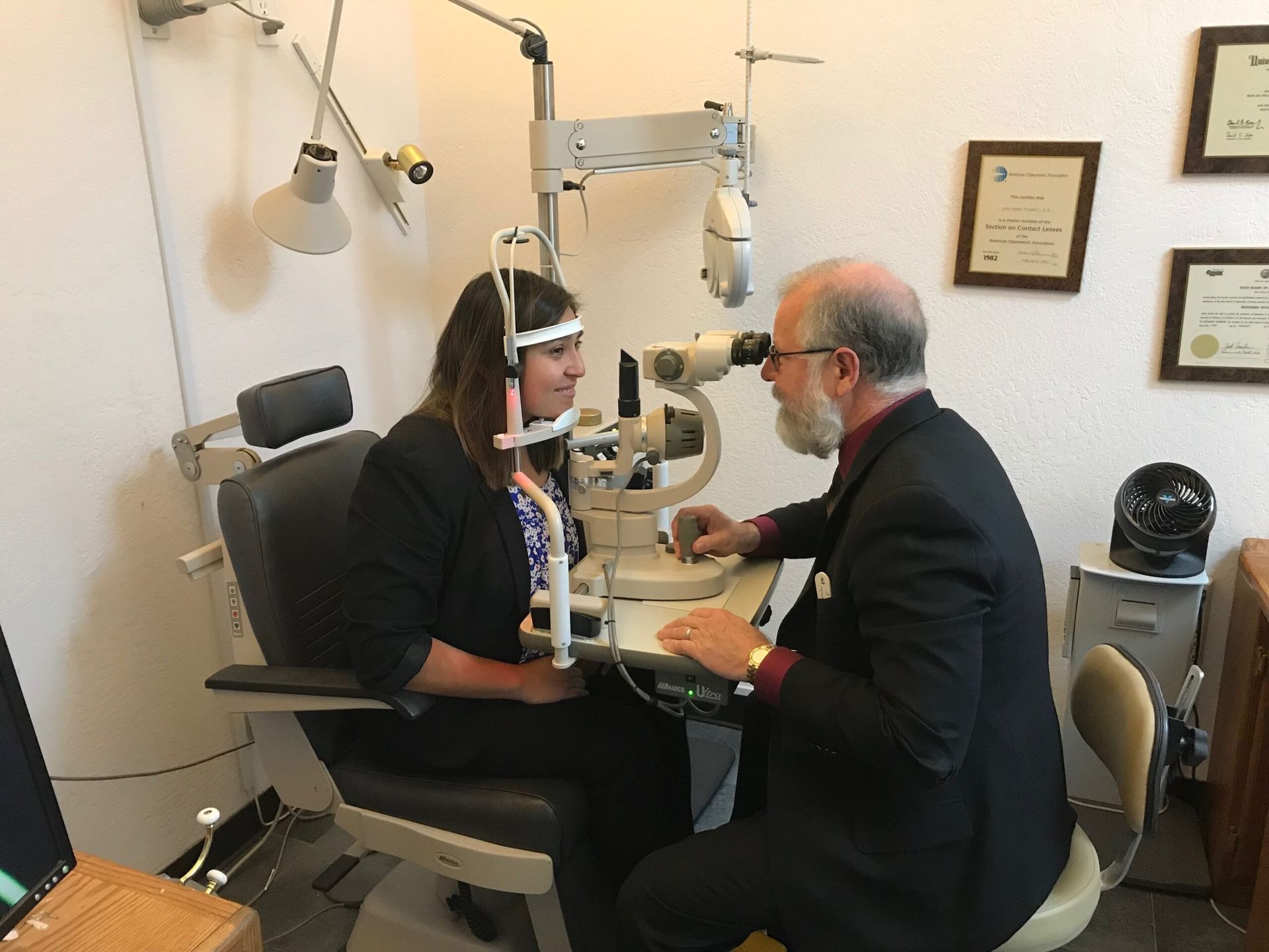 Dr. Prewett examining a patient's eye at the slit lamp