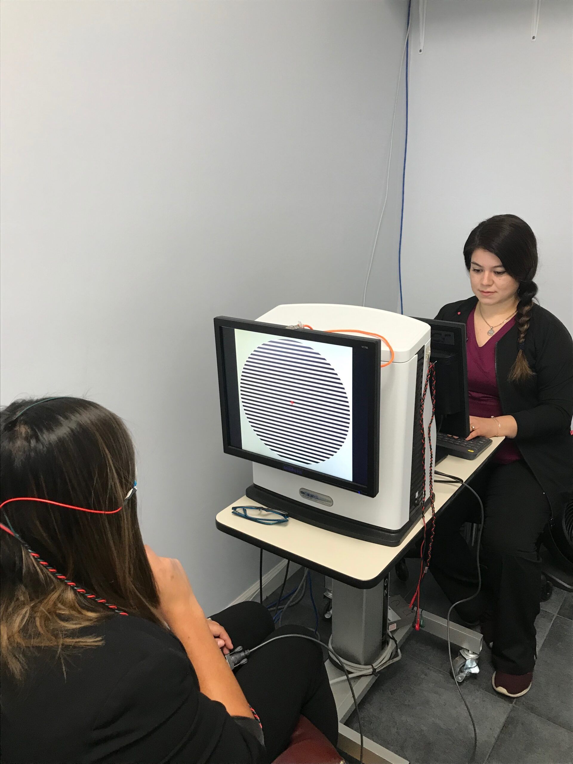 Patient taking a visual field test with a technician